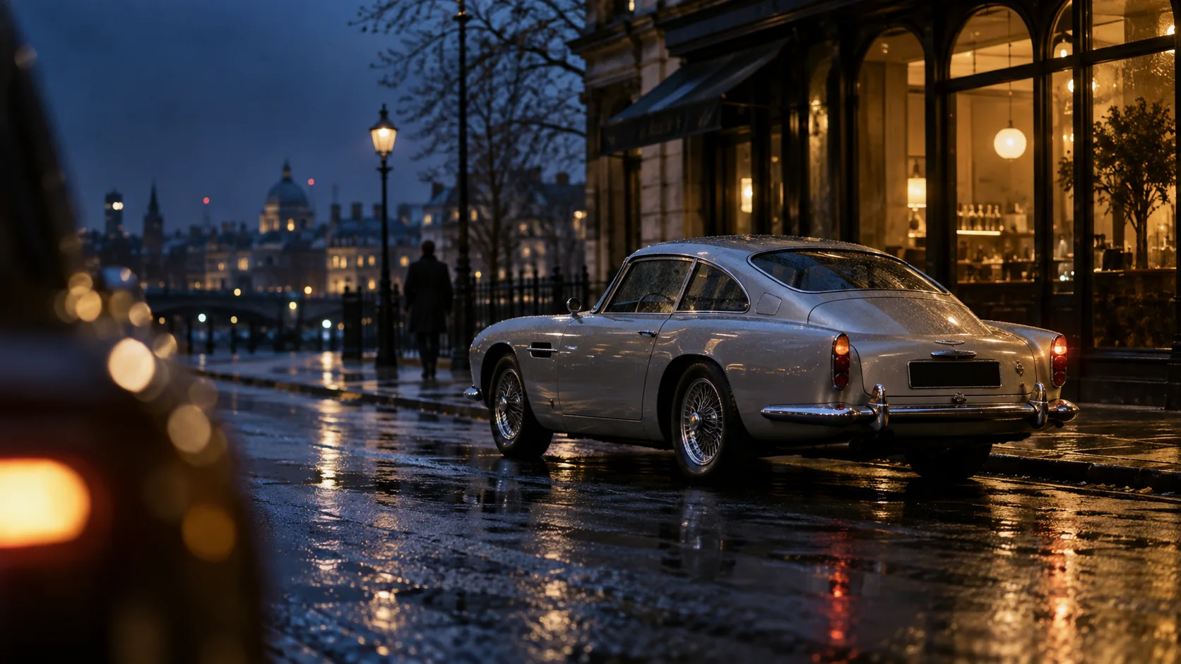 A silver classic coupe on a rainy evening